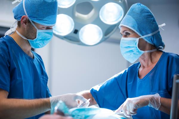 Surgeons perform operations in the operating room.